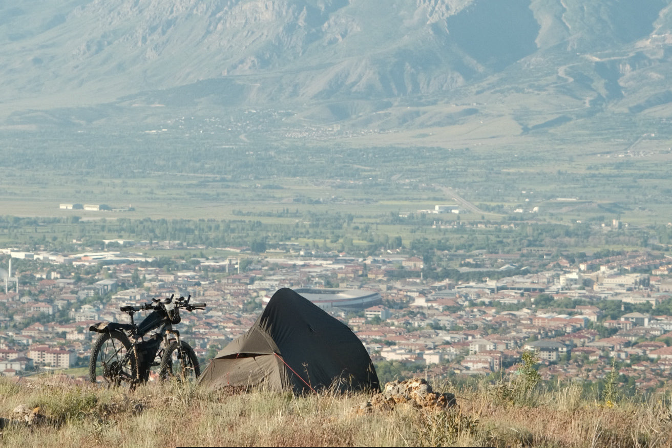 Elliot Silander's tent and loaded touring bicycle pitched on a ridge above the Erzincan valley in Turkey.